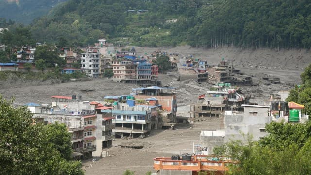 Aerial view of a flood-damaged riverside town.